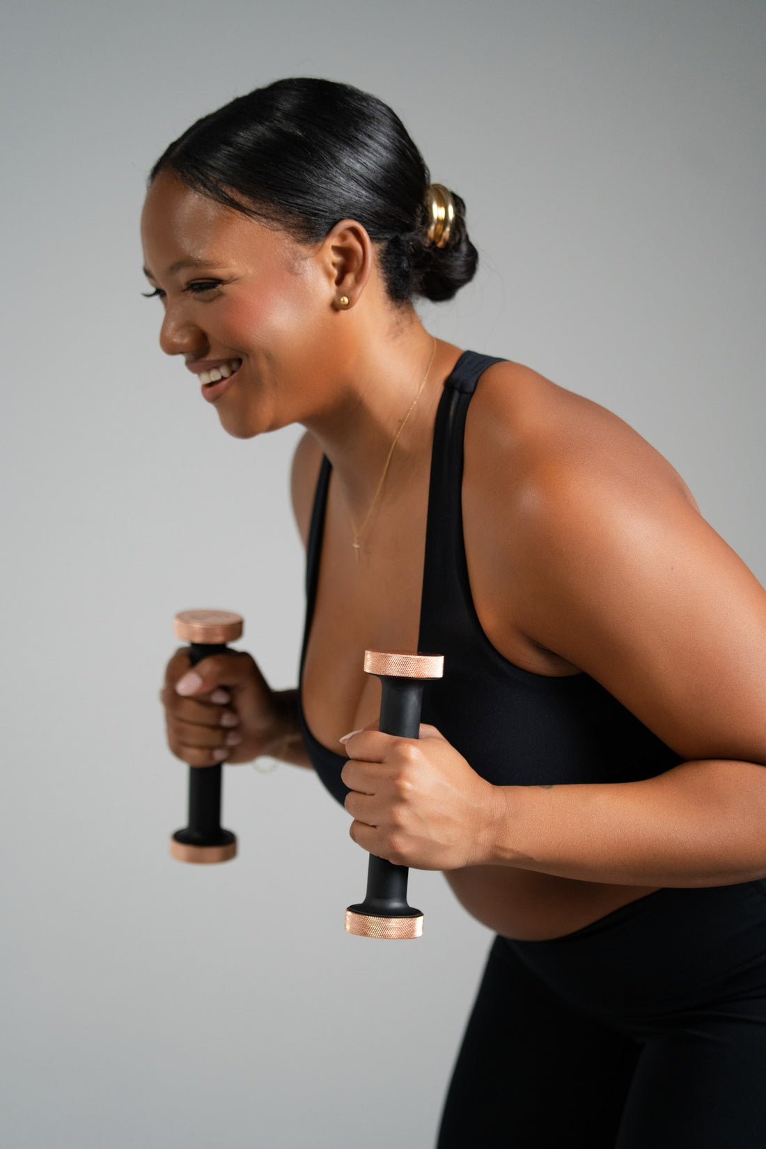 Smiling woman lifting dumbbells workout